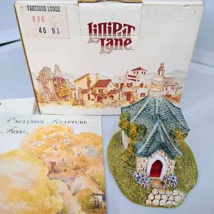Decorative house sculpture with 'Kipper Lane' packaging on a light blue background