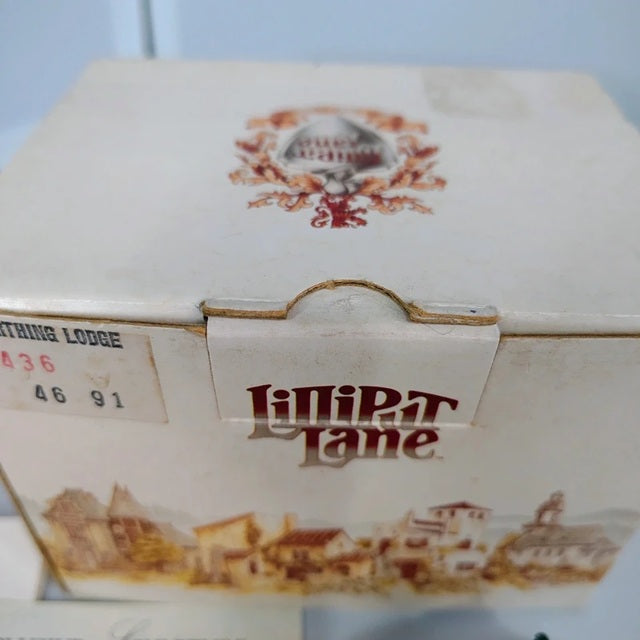 Vintage-style box with 'Lilliput Lane' branding and decorative elements.