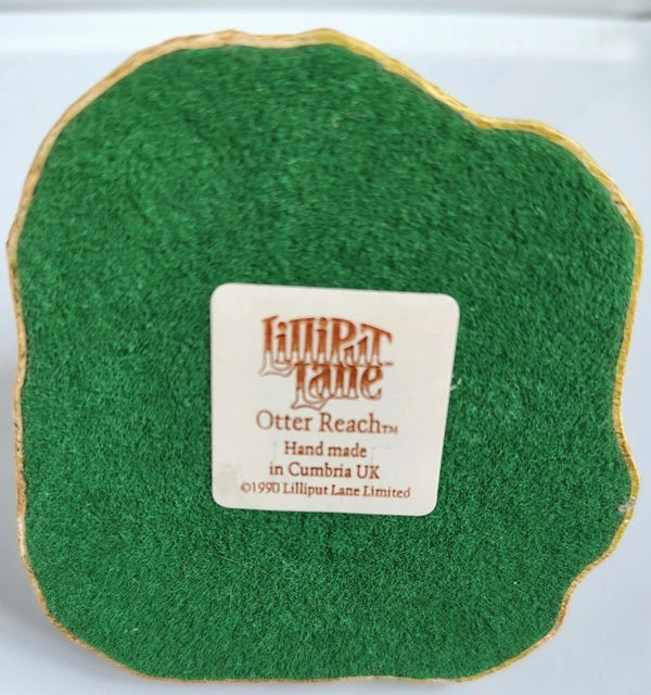 Green fabric swatch with a Lilliput Lane label on a white background