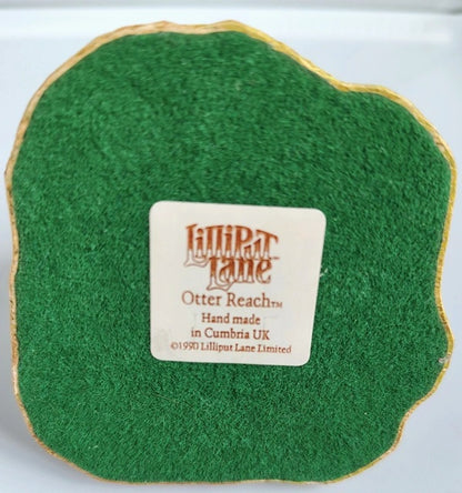 Green fabric swatch with a Lilliput Lane label on a white background