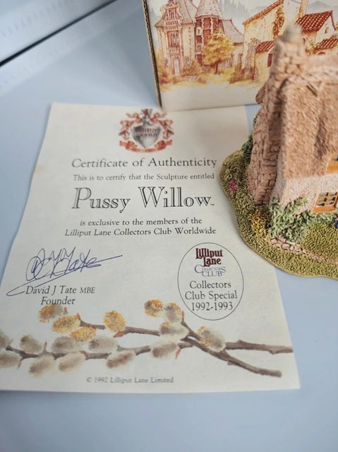 A certificate of authenticity for the sculpture 'Pussy Willow' by David J. Tate, shown alongside a small painted model of a willow tree on a grassy base.