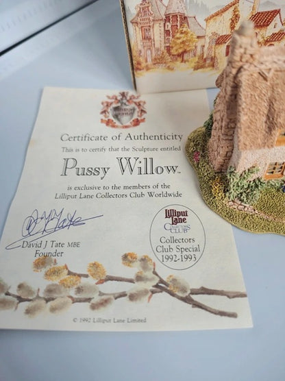 A certificate of authenticity for the sculpture 'Pussy Willow' by David J. Tate, shown alongside a small painted model of a willow tree on a grassy base.