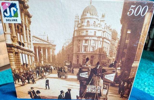 Jigsaw puzzle box with vintage city scene and JC Deluxe branding