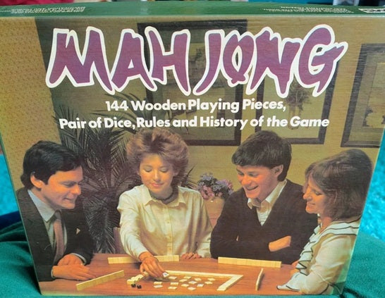 Box of a Mahjong game with four people playing