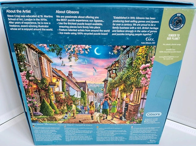 Gibsons puzzle box with a colorful illustration of a village scene on a blue background