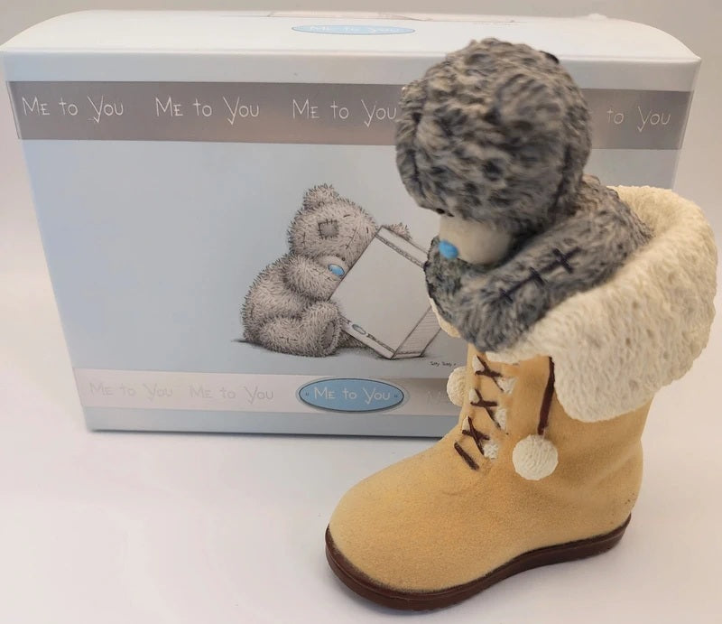 A Me To You  Snug Boot tatty teddy bear figurine wearing a gray fuzzy hat and a cream faux-fur collar, posed in front of its original light blue and white packaging box.