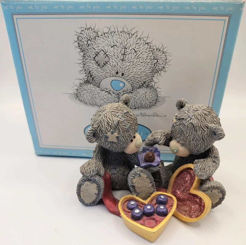 A Me To You Sweet Love teddy bear figurine set featuring two gray textured bears sitting together with a heart-shaped box of purple candies and a small purple flower, placed in front of its light blue branded box.