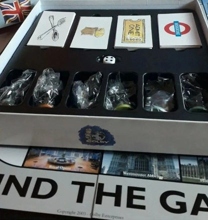 Board game components including cards and dice in a box with 'Find the Gap' branding.