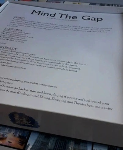 Close-up of 'Mind The Gap' board game instructions with text and branding.