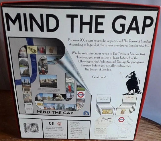 Board game box titled 'Mind the Gap' with images and text on a wooden surface.