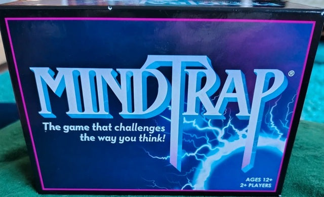 MindTrap game box with blue and purple design on a green surface