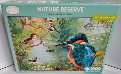 Jigsaw puzzle box featuring nature-themed artwork with birds and a lake, labeled 'Nature Reserve' by Pollyanna Pickering.