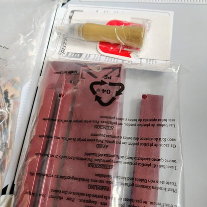 Packaged product with red tools and text on a white background