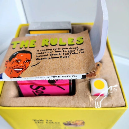 Product packaging with a book titled 'The Rules' featuring a cartoon character, a pink object, and a white object with a yellow circle.