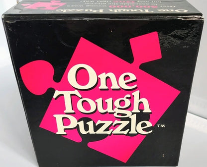 Box of 'One Tough Puzzle' with pink and white design on a black background