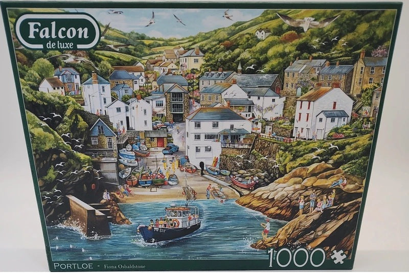 Portloe a 1000-piece jigsaw puzzle box by Falcon de luxe, featuring a colorful illustration of the coastal town Portloe with boats, rocky cliffs, and green hills.