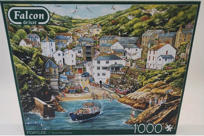 Portloe a 1000-piece jigsaw puzzle box by Falcon de luxe, featuring a colorful illustration of the coastal town Portloe with boats, rocky cliffs, and green hills.