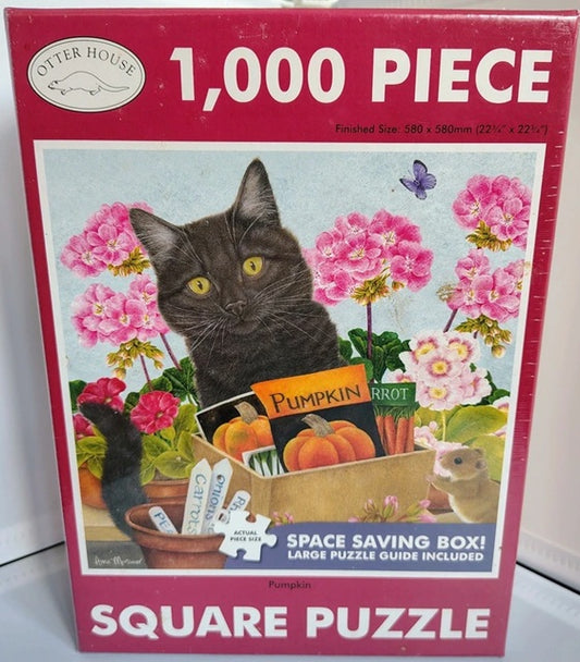 Jigsaw puzzle box with a cat and pumpkin design on a pink background