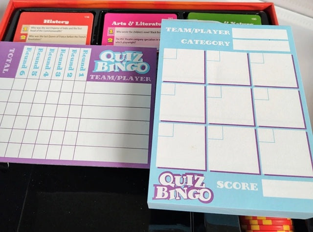 Quiz Bingo score sheets with a red border on a black surface