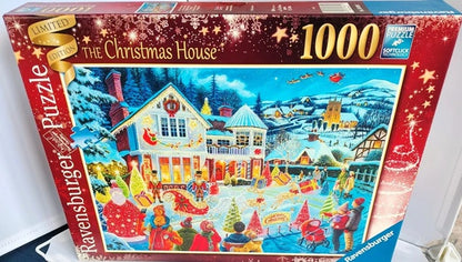 Jigsaw puzzle box titled 'The Christmas House' with a festive scene on the cover.