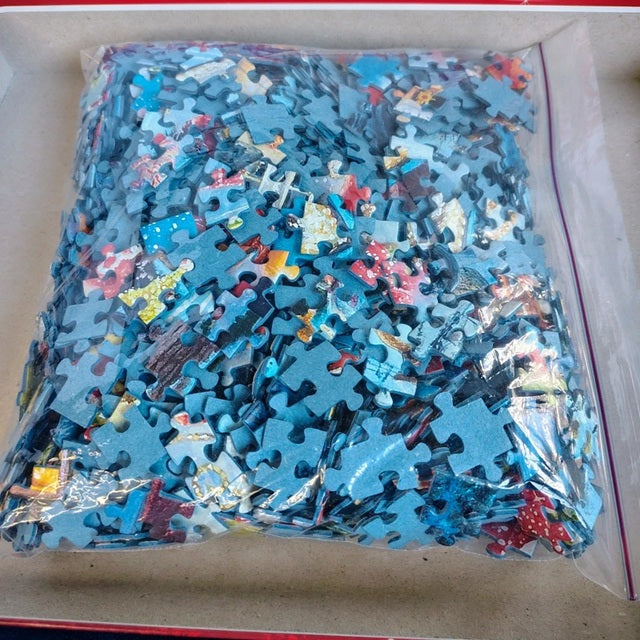 Bag of assorted puzzle pieces with a focus on blue pieces.