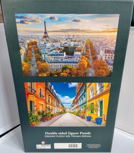 Double-sided jigsaw puzzle box with images of Paris and colorful street scenes.