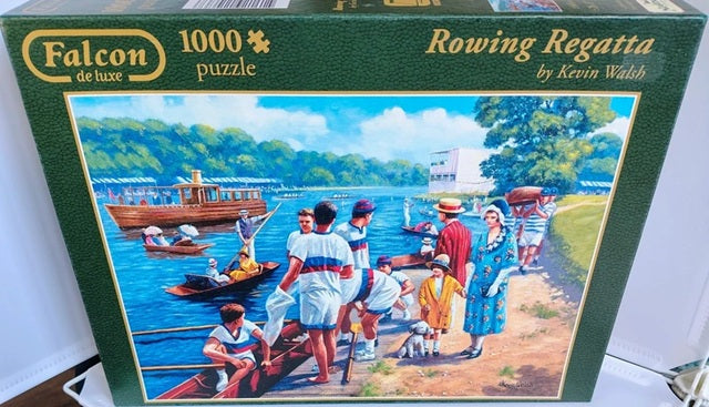 Falcon Rowing Regatta jigsaw puzzle box with a scenic illustration of people by a lake.