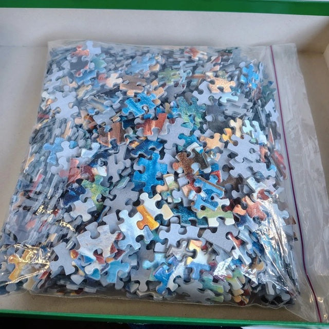 Bag of puzzle pieces with a colorful assortment on a white background