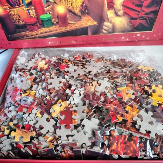 Jigsaw puzzle pieces in a box with a partially completed puzzle on top