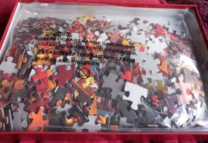 Jigsaw puzzle in a box with a warning label on a red surface