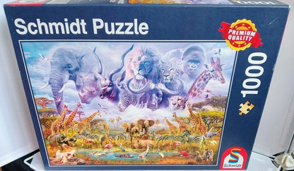 African wildlife including elephants, lions, giraffes, zebras and flamingos gathered at a waterhole in a colourful 1000 piece jigsaw puzzle scene.