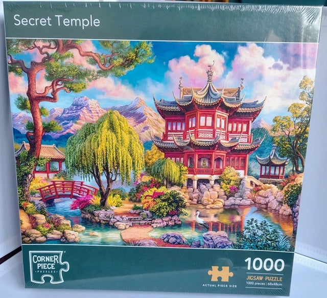 Jigsaw puzzle packaging with a colorful temple design on a blue background