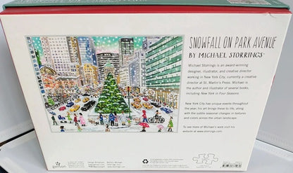 Back of a puzzle box with a colorful illustration of a snowy city scene and text about Michael Storrings.