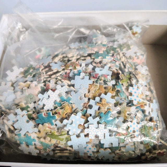 Jigsaw puzzle pieces in a clear plastic bag on a light blue background