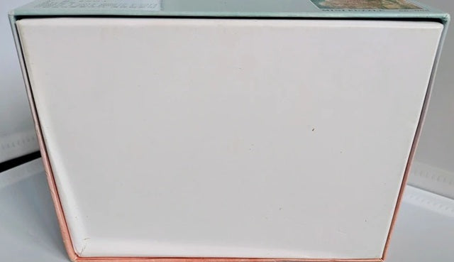 White rectangular object with rose gold border on a white background