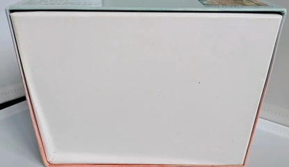 White rectangular object with rose gold border on a white background