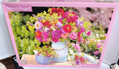 Colourful summer bouquet of mixed flowers in a white vase with a garden background.