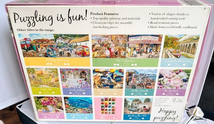 Back of a jigsaw puzzle box showing multiple puzzle designs and product features.