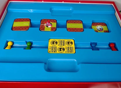 Board game with colorful tiles and a yellow 'Super Mario' card on a blue tray.