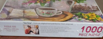 Tea time-themed puzzle box with a cup, saucer, and flowers on a table.