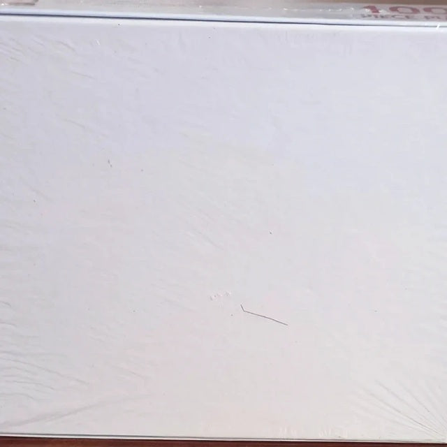 White mattress with visible stitching and a brown border