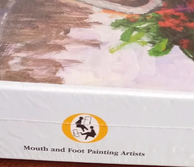 Product packaging with 'Mouth and Foot Painting Artists' logo on a textured surface.