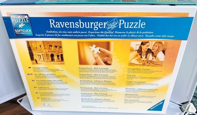 Ravensburger puzzle box with images of people working on a puzzle and architectural elements.