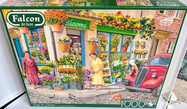 Falcon de luxe puzzle box featuring a florist shop scene with people and flowers.
