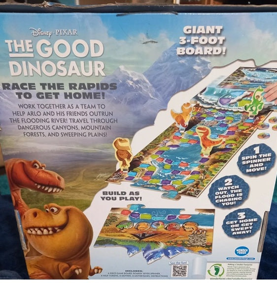 Box of 'The Good Dinosaur' board game with dinosaur illustrations and game instructions.