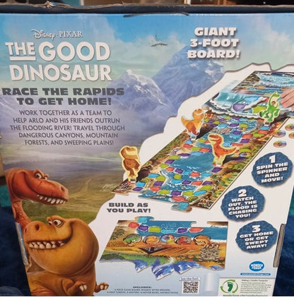 Box of 'The Good Dinosaur' board game with dinosaur illustrations and game instructions.