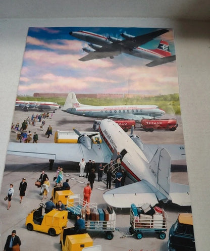 A vintage-style illustrated poster or print depicting an airport scene with multiple airplanes on the tarmac, passengers, luggage carts, and ground crew under a cloudy sky. The artwork appears to be the product itself rather than a photo of a physical object in use.