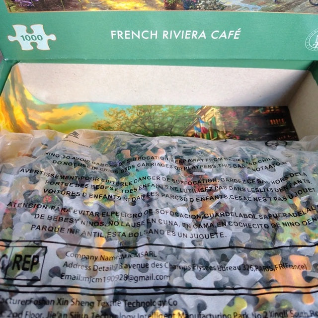 Jigsaw puzzle box for 'French Riviera Café' with a scenic image on the top.