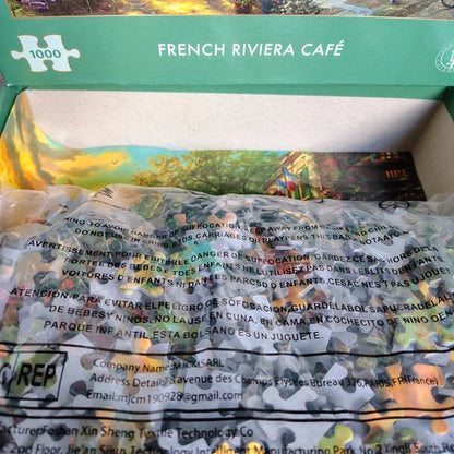 Jigsaw puzzle box for 'French Riviera Café' with a scenic image on the top.