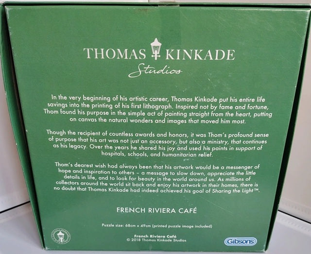 Back of a Thomas Kinkade Studios puzzle box with text and branding.
